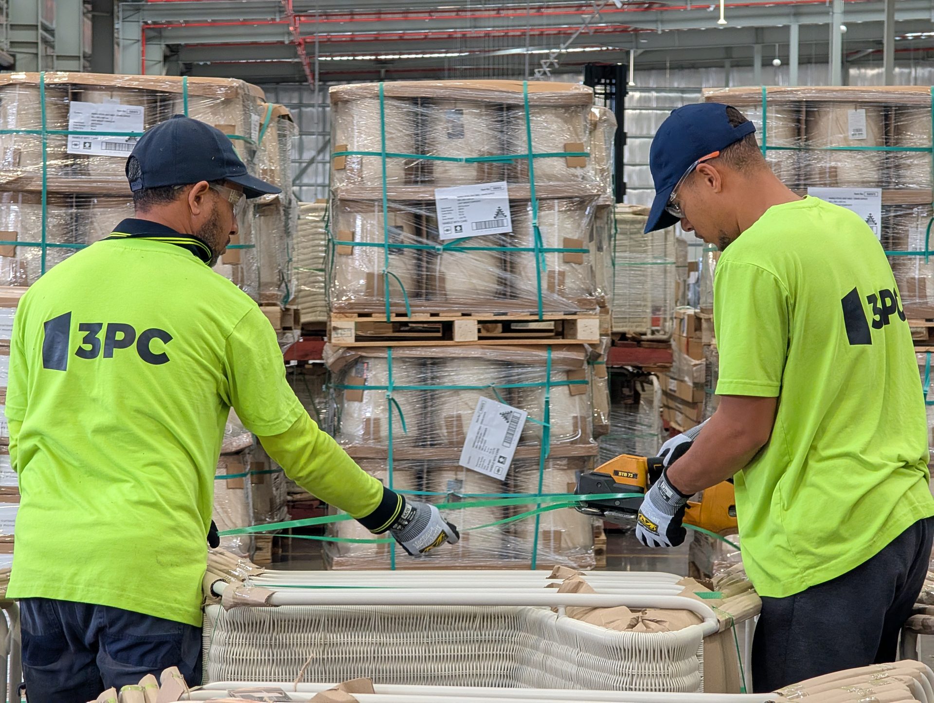 3PC forklift operator navigating a warehouse aisle stacked with palletised stock