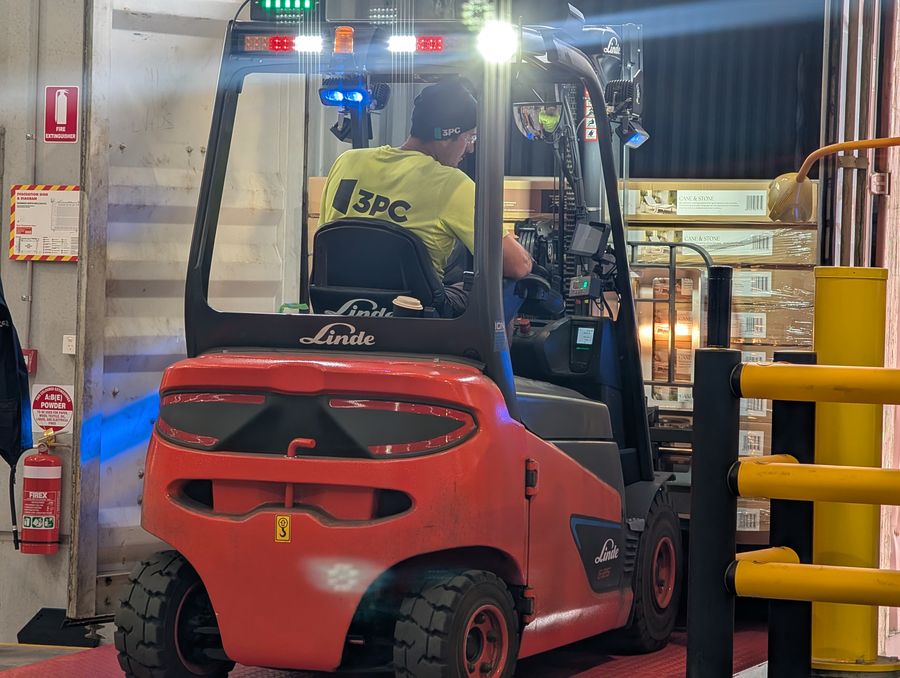 3PC forklift operator working safely inside a customer DC